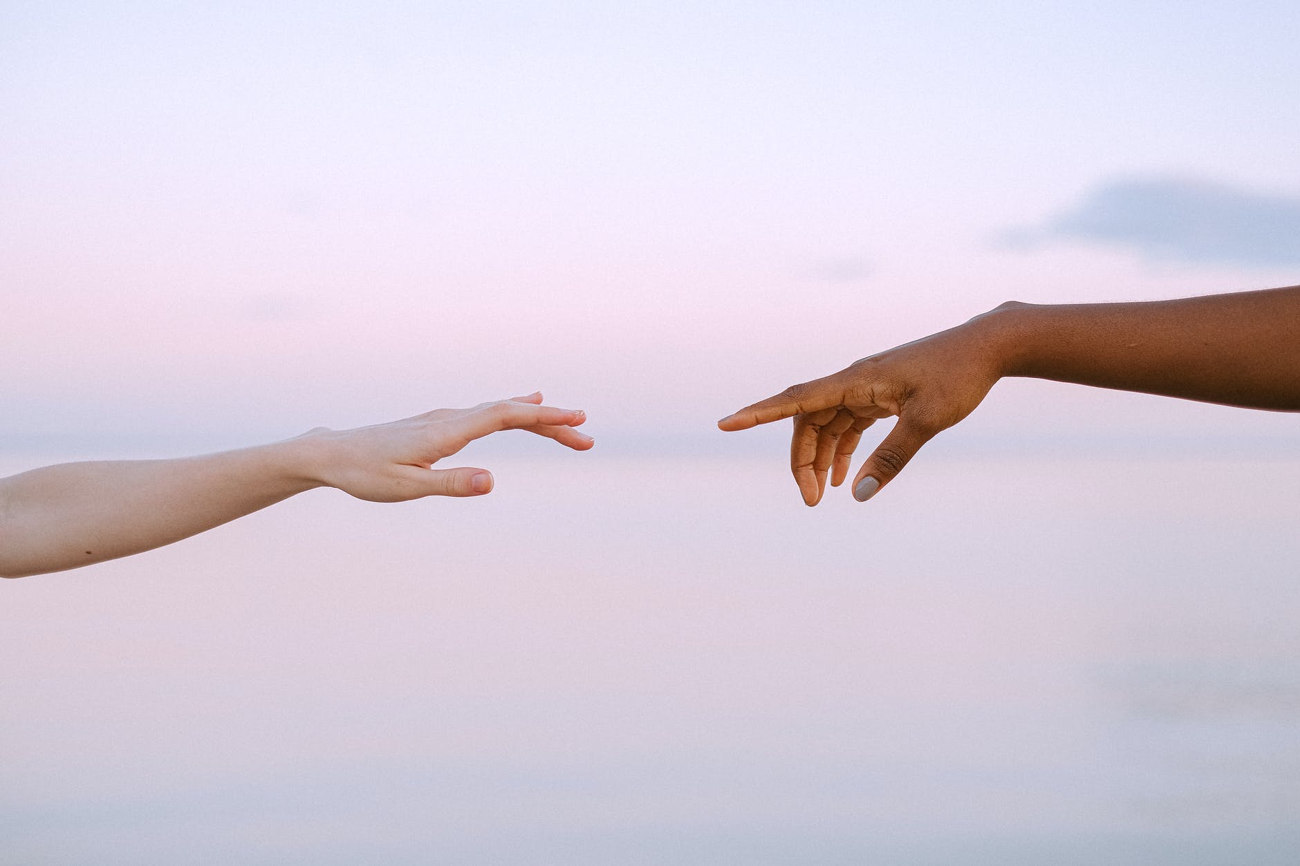 photo of people reaching each other s hands