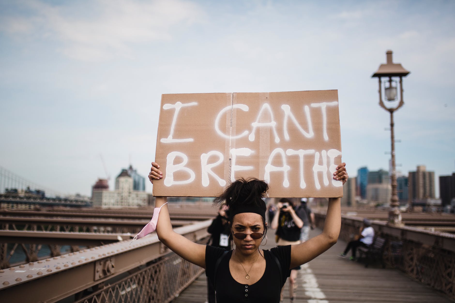 photo of woman carrying a cardboard