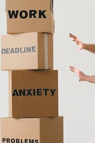 man near carton boxes with many different words about stress